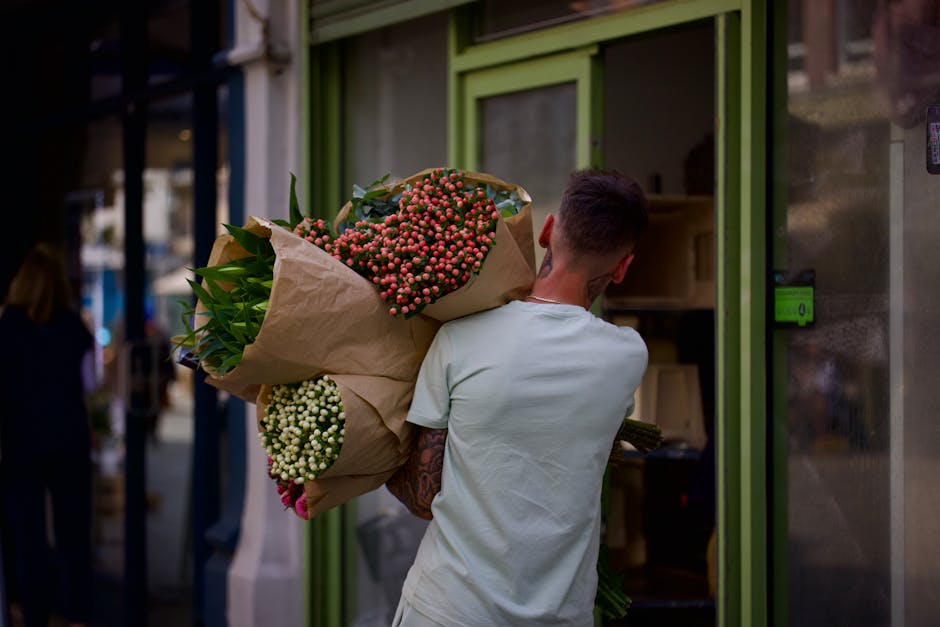 A display of fresh flower bouquets and arrangements at Wheeler of Chiswick, situated in an underground station. The arrangement features a variety of vibrant, seasonal flowers including sunflowers, ro